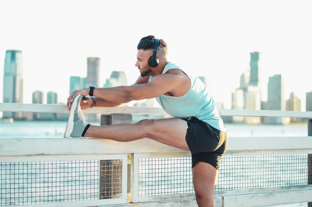 A person performing a stretching exercise in a serene outdoor setting, showcasing flexibility and movement.