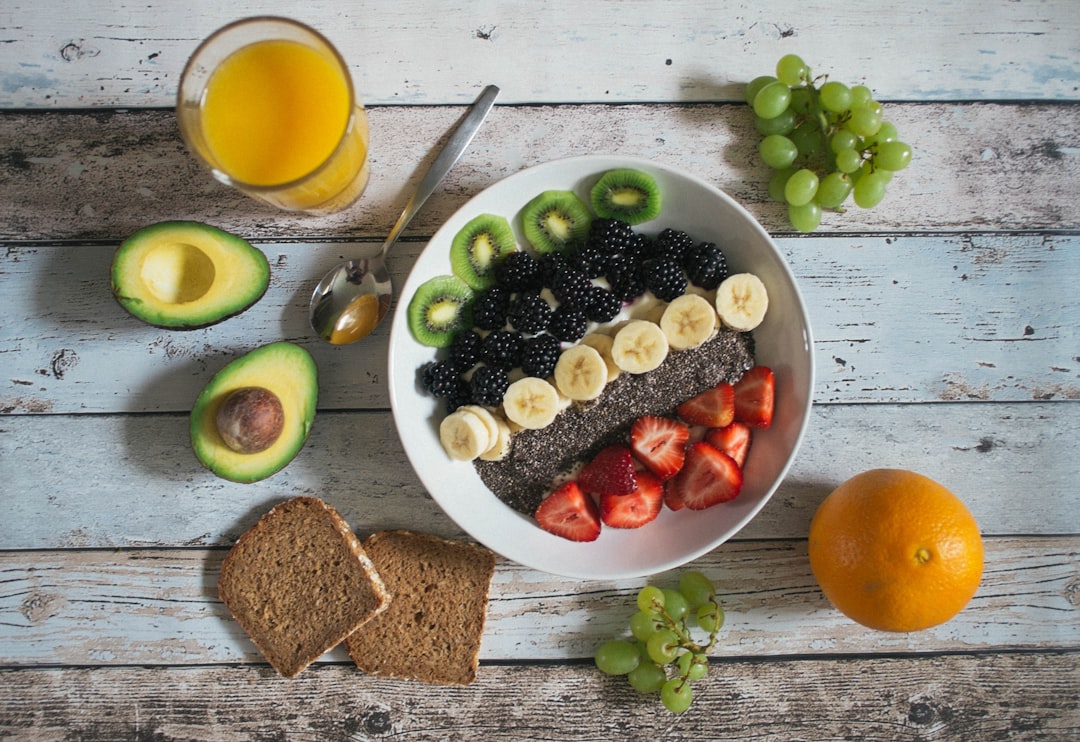 A vibrant and healthy vegan meal prep with colorful vegetables and protein sources, alongside workout gear like dumbbells and a yoga mat.