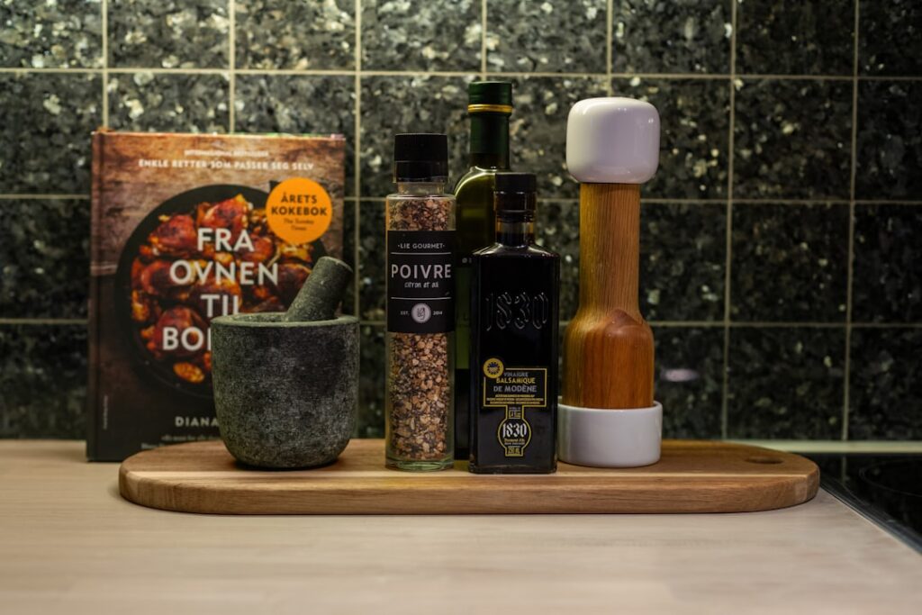 A wooden cutting board topped with spices and bottles