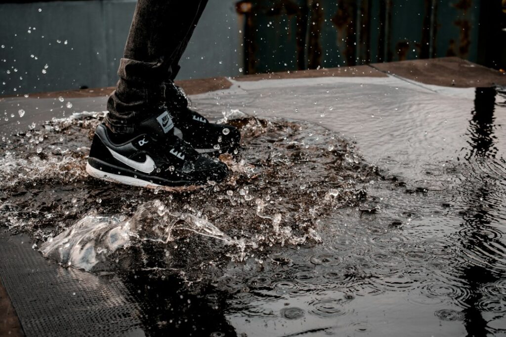 man splashing water on ground
