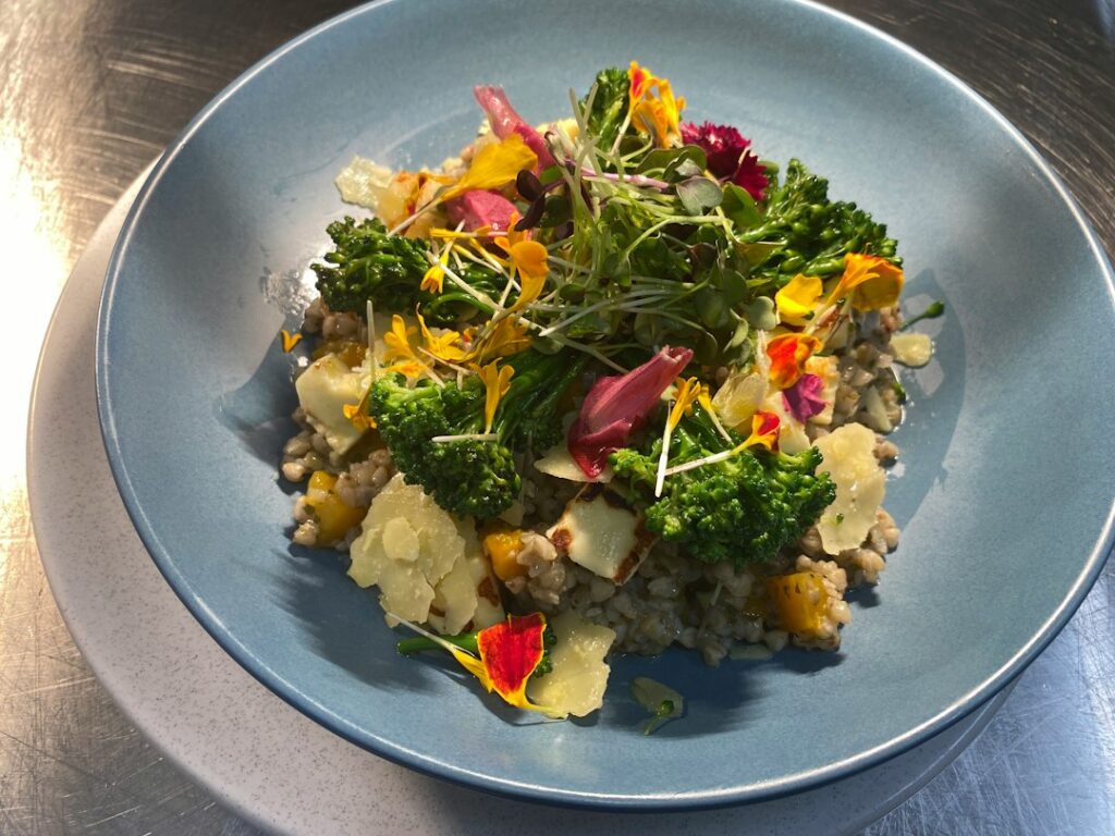 A plate of food with broccoli, cauliflower, and other vegetables